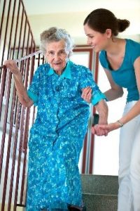 old women getting help walking down the stairs