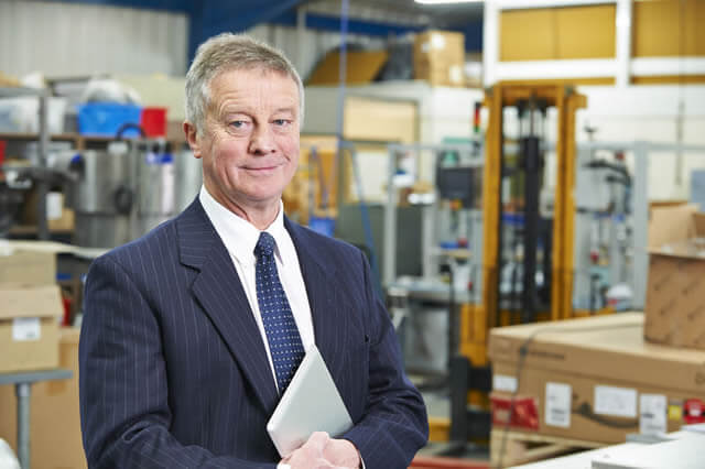 Man in suit holding a tablet; Estate Executors: It's a Thankless Job
